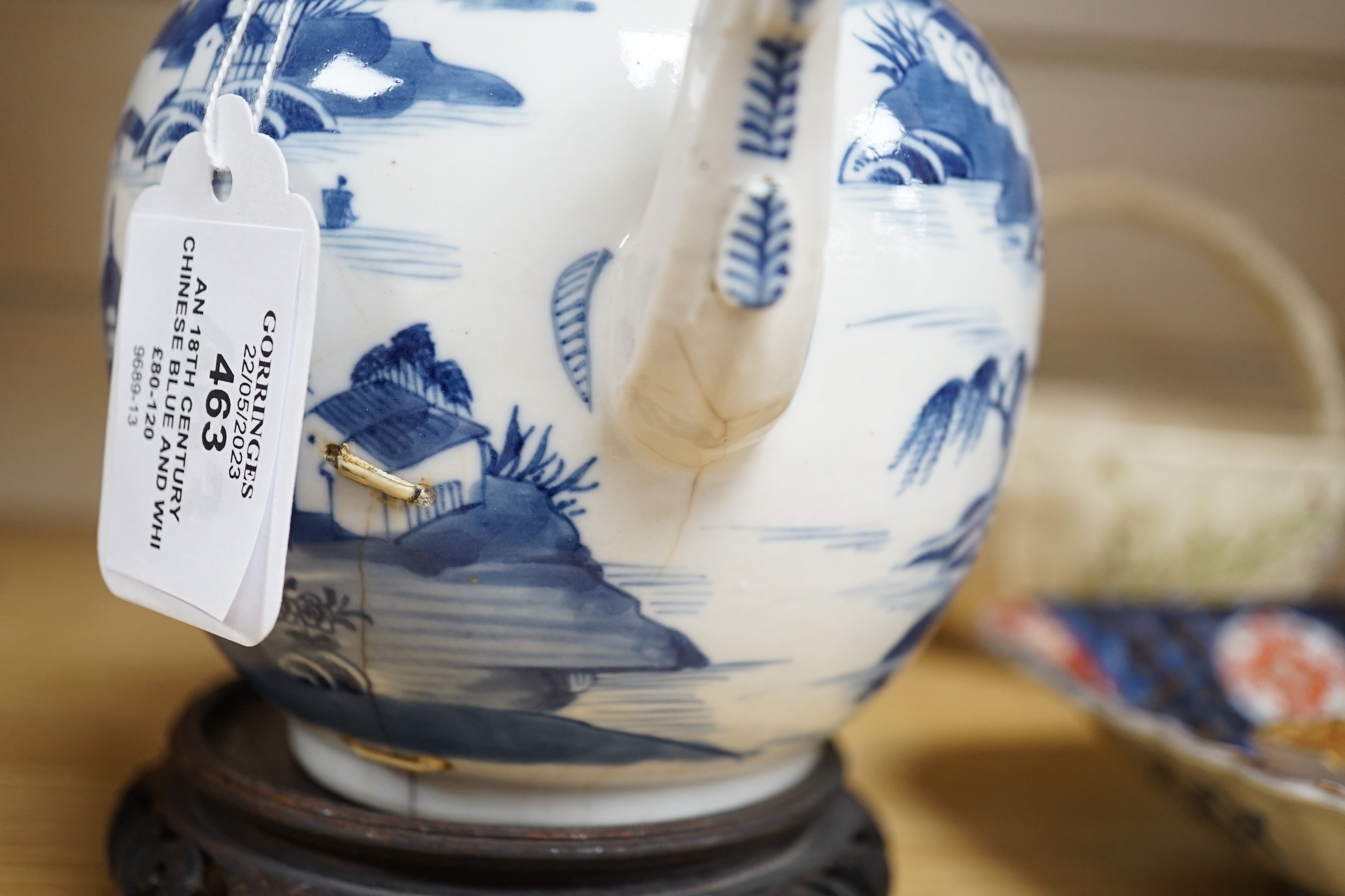 An 18th century Chinese blue and white teapot and cover, with hardwood stand, 19cm total height